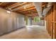 Unfinished basement featuring concrete floor, exposed ceiling, and a door leading to the exterior at 2892 Guinevere Ne Dr, Atlanta, GA 30345