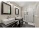 This renovated bathroom has double sinks and a glass-enclosed shower at 2892 Guinevere Ne Dr, Atlanta, GA 30345