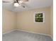 This cozy bedroom features neutral walls, a ceiling fan, and soft carpet at 2892 Guinevere Ne Dr, Atlanta, GA 30345