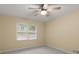 Bedroom featuring a ceiling fan, window, and carpeted floors at 2892 Guinevere Ne Dr, Atlanta, GA 30345