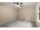This bedroom features soft carpet, natural light, and a ceiling fan at 2892 Guinevere Ne Dr, Atlanta, GA 30345