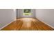 Bright bedroom featuring beautiful hardwood flooring and a large window offering scenic outdoor views at 2892 Guinevere Ne Dr, Atlanta, GA 30345