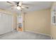 This bedroom boasts neutral walls, gray carpet, a ceiling fan, and a double door closet for ample storage at 2892 Guinevere Ne Dr, Atlanta, GA 30345