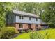 Charming two-story home with a well-manicured lawn, brick accents, and attached two car garage at 2892 Guinevere Ne Dr, Atlanta, GA 30345