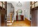 Bright foyer with hardwood floors, staircase with iron railing, and a classic chest at 2892 Guinevere Ne Dr, Atlanta, GA 30345