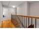 Hardwood staircase featuring modern wrought iron spindles and wood railing leading to bedrooms at 2892 Guinevere Ne Dr, Atlanta, GA 30345