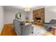 Cozy living room features a brick fireplace, hardwood floors, and a neutral color palette at 2892 Guinevere Ne Dr, Atlanta, GA 30345