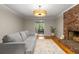 Living room with brick fireplace, hardwood flooring, recessed lighting, and neutral décor at 2892 Guinevere Ne Dr, Atlanta, GA 30345