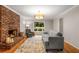 Comfortable living room with hardwood floors, brick fireplace, neutral walls, and cozy decor at 2892 Guinevere Ne Dr, Atlanta, GA 30345