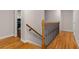 Hardwood staircase featuring modern wrought iron spindles and wood railing at 2892 Guinevere Ne Dr, Atlanta, GA 30345