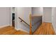 Wood staircase with decorative iron railing and hardwood floors at 2892 Guinevere Ne Dr, Atlanta, GA 30345