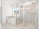 Bathroom with a glass-enclosed shower, soaking tub, and tiled walls and floors at 3514 Ambassador Aly, Scottdale, GA 30079