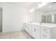 Bright bathroom features a double vanity with white cabinets, quartz countertops, and modern fixtures at 3514 Ambassador Aly, Scottdale, GA 30079