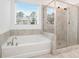 Bright bathroom showcasing a soaking tub and separate glass-enclosed shower, offering a spa-like experience at 3514 Ambassador Aly, Scottdale, GA 30079