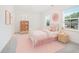 A cute bedroom with soft colors, natural light, a cozy bed, and sweet decorative touches at 3514 Ambassador Aly, Scottdale, GA 30079