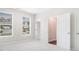 Bright bedroom featuring plush carpeting, natural light from large windows, and white doors at 3514 Ambassador Aly, Scottdale, GA 30079