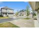 Street view featuring multiple homes with garages and well-manicured lawns under a clear blue sky at 3514 Ambassador Aly, Scottdale, GA 30079