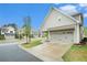 Charming home with a welcoming driveway leading to a two-car garage and well-maintained landscaping at 3514 Ambassador Aly, Scottdale, GA 30079