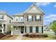 Charming two-story home featuring a stone facade, landscaped front yard, and inviting front porch at 3514 Ambassador Aly, Scottdale, GA 30079