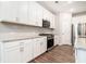 Well-lit kitchen features white cabinets, stainless steel appliances, and granite countertops at 3514 Ambassador Aly, Scottdale, GA 30079