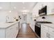 Modern kitchen featuring white cabinetry, stainless steel appliances, and granite countertops at 3514 Ambassador Aly, Scottdale, GA 30079