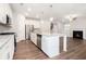 Open kitchen with a large island, stainless appliances, and views into the living room at 3514 Ambassador Aly, Scottdale, GA 30079