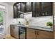 Modern bar area with custom cabinets, a beverage cooler, and stylish countertops perfect for entertaining guests at 560 Morgan Ne St, Atlanta, GA 30308
