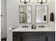 Modern bathroom featuring double vanity, marble countertop, and black framed mirrors at 560 Morgan Ne St, Atlanta, GA 30308