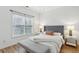 Charming bedroom with a large window, modern decor, and hardwood floors at 560 Morgan Ne St, Atlanta, GA 30308