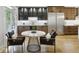 Cozy dining area with a marble table, comfortable chairs, and access to a modern bar with stainless steel appliances at 560 Morgan Ne St, Atlanta, GA 30308