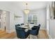 Elegant dining room with a modern chandelier, a glass-topped table with seating for six, and natural light at 560 Morgan Ne St, Atlanta, GA 30308