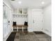 Bright entryway boasts slate tile, storage hooks, built-in bench, and access to the exterior through sliding glass doors at 560 Morgan Ne St, Atlanta, GA 30308