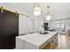 Open kitchen with a large island, modern lighting, and access to the living area and outdoor patio at 560 Morgan Ne St, Atlanta, GA 30308