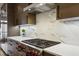 Close up of a kitchen with stainless steel appliances, marble backsplash, and custom cabinetry at 560 Morgan Ne St, Atlanta, GA 30308