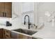 Kitchen sink area with modern faucet, stainless steel farmhouse sink, and marble countertops and backsplash at 560 Morgan Ne St, Atlanta, GA 30308