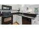 Well-lit kitchen featuring sleek black appliances and granite countertops at 560 Morgan Ne St, Atlanta, GA 30308