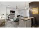 Combined living space with a bar, TV, and comfortable green velvet sofa at 560 Morgan Ne St, Atlanta, GA 30308