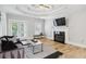 Bright living room with a fireplace, hardwood floors, a comfortable sofa, and access to the outdoor balcony at 560 Morgan Ne St, Atlanta, GA 30308