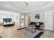 Spacious main bedroom with a tray ceiling, hardwood floors, and a seating area at 560 Morgan Ne St, Atlanta, GA 30308