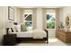 Cozy bedroom with a bed, side table, mirror, dresser, and an abundance of natural light at 811 Atkins Ln, Woodstock, GA 30188