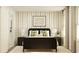 Primary bedroom featuring a bed, bedside tables with lamps, and light-colored vertical striped wallpaper at 811 Atkins Ln, Woodstock, GA 30188