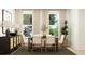 Dining room featuring a table with chairs, decorative plants, and a cabinet with rattan doors at 811 Atkins Ln, Woodstock, GA 30188