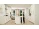 Open-concept kitchen featuring a large island, white cabinetry, and stainless steel appliances at 811 Atkins Ln, Woodstock, GA 30188