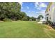 Sprawling backyard with a lush green lawn, mature trees, and ample space for recreation and outdoor activities at 105 Pine Valley Ct, Hiram, GA 30141
