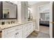 Well-lit bathroom with double vanity, granite countertop, and views of the bedroom through doorway at 105 Pine Valley Ct, Hiram, GA 30141