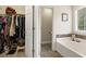 Bathroom featuring a walk-in closet and a bathtub with mosaic tile accents at 105 Pine Valley Ct, Hiram, GA 30141