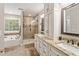 Luxurious bathroom featuring a soaking tub, glass-enclosed shower, and dual vanity sinks at 105 Pine Valley Ct, Hiram, GA 30141