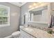 Bathroom features a granite countertop, gray walls, and a decorative mirror at 105 Pine Valley Ct, Hiram, GA 30141