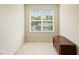 Cozy bonus room featuring neutral walls, plush carpeting, and a large window offering plenty of natural light at 105 Pine Valley Ct, Hiram, GA 30141