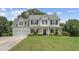 Charming two-story home boasts a manicured lawn and inviting columned front porch at 105 Pine Valley Ct, Hiram, GA 30141